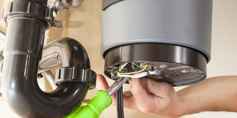 Technician repairing the heating element of a water heater in Rome