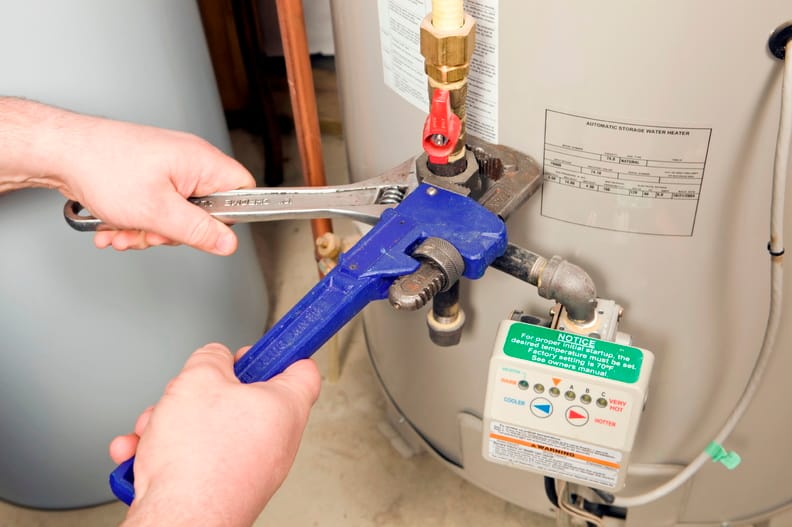 Plumber repairing a water heater valve in Rome
